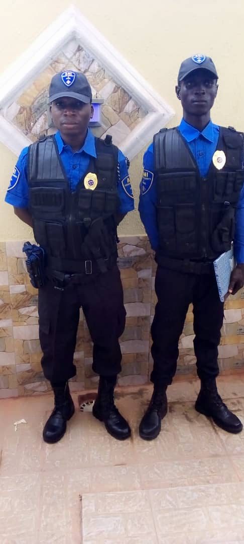 Two ANI officers in blue uniform and tactical vests at a client post