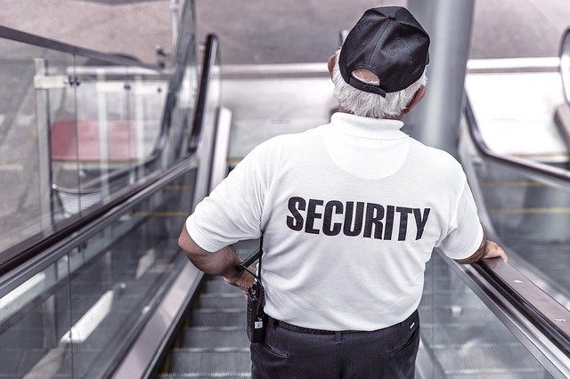 Security officer managing a public retail concourse